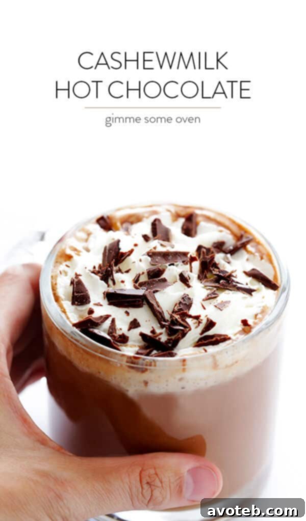 Velvet Nut Blend Hot Chocolate 8 Stacked mugs of Almondmilk Cashewmilk Hot Chocolate, with one topped with whipped cream and chocolate shavings. Cozy and inviting. | gimmesomeoven.com