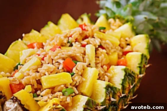 Pineapple Fried Rice | gimmesomeoven.com Delicious Pineapple Fried Rice served in a pineapple half.