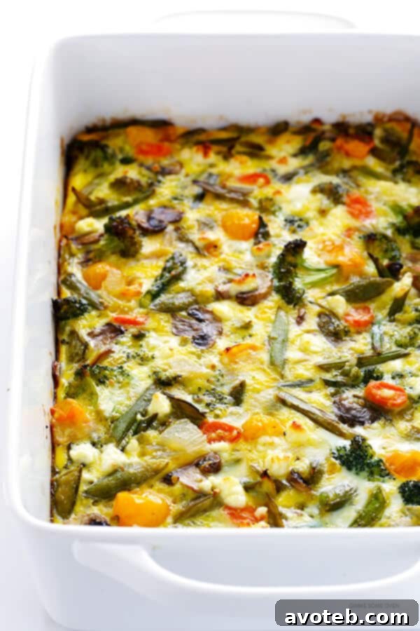 Fresh Spring Egg Bake 7 A slice of the glorious Spring Vegetable Breakfast Casserole, showcasing vibrant veggies, fluffy eggs, and savory cheese, ready to be enjoyed as an easy and delicious meal.