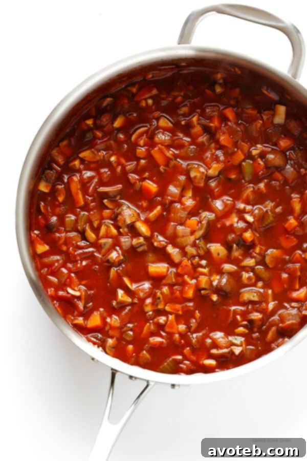 Hearty Mushroom Ragu 4 Colorful mirepoix of diced carrots, celery, and onions with garlic and mushrooms in a pan.