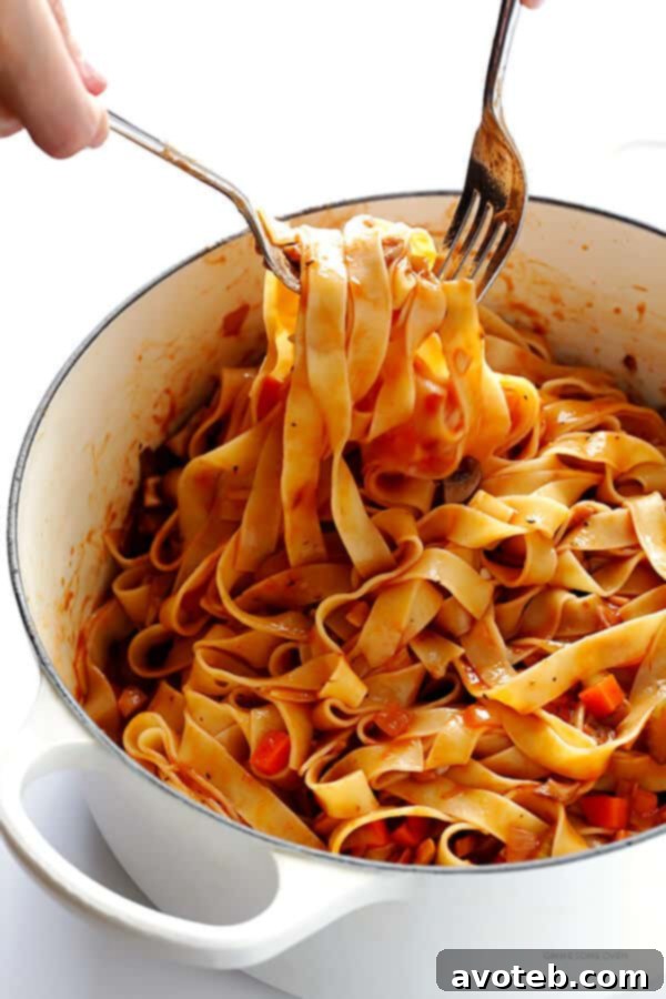 Hearty Mushroom Ragu 6 Mushroom bolognese sauce generously tossed with tagliatelle pasta in a large bowl.