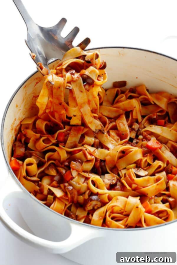 Hearty Mushroom Ragu 8 Delicious Mushroom Bolognese pasta garnished with herbs, ready to eat.