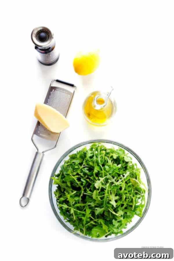 A vibrant close-up of the 5-Ingredient Arugula Salad, showcasing its fresh ingredients and inviting texture. A quick, healthy, and delicious meal option. | gimmesomeoven.com