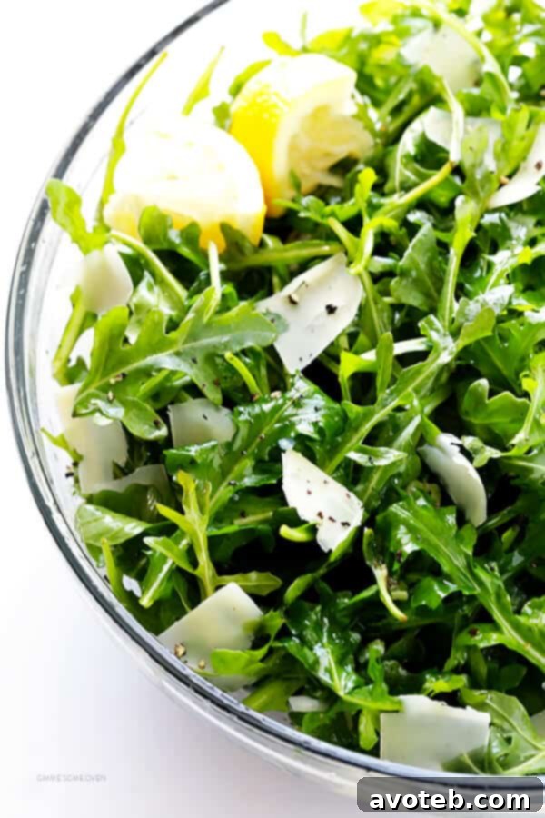 The perfectly tossed 5-Ingredient Arugula Salad, ready to be served. A testament to quick, healthy, and delicious eating. | gimmesomeoven.com