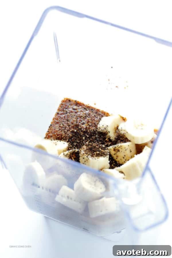 Close-up of frozen bananas, Blue Diamond Almond Breeze, Greek yogurt, and chai tea leaves – ingredients for a perfect Banana Chai Smoothie.