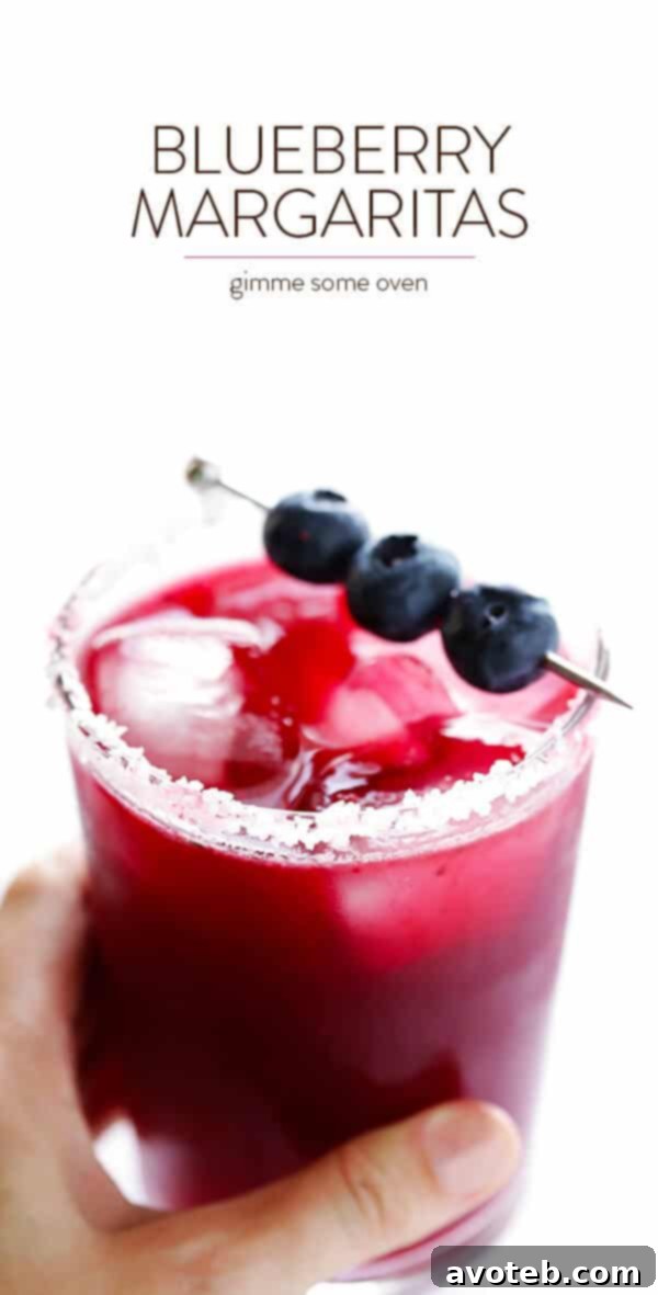 An inviting overhead shot of two blueberry margaritas in salt-rimmed glasses, perfect for sharing.