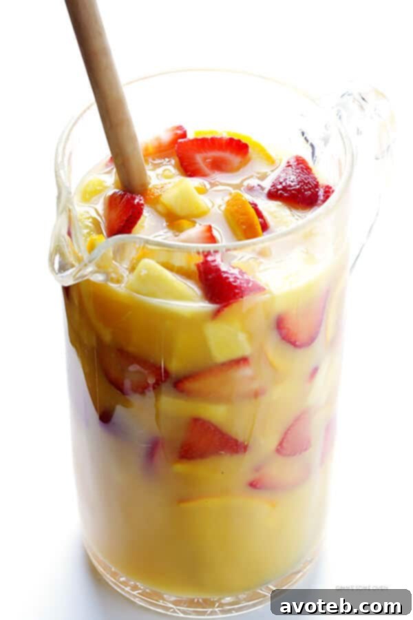 Mimosa Sangria -- quick and easy to make, and kicked up a notch with lots of delicious fresh fruit!