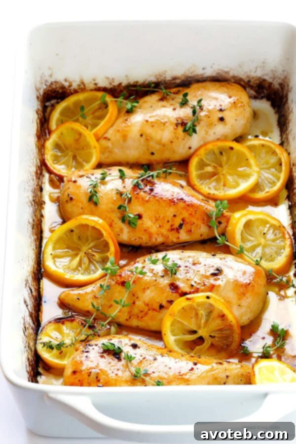 Perfectly Juicy Baked Lemon Chicken Breasts with fresh lemon slices and thyme