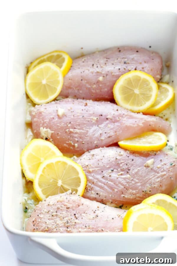 Lemon slices and fresh thyme sprigs arranged for garnish on baked chicken