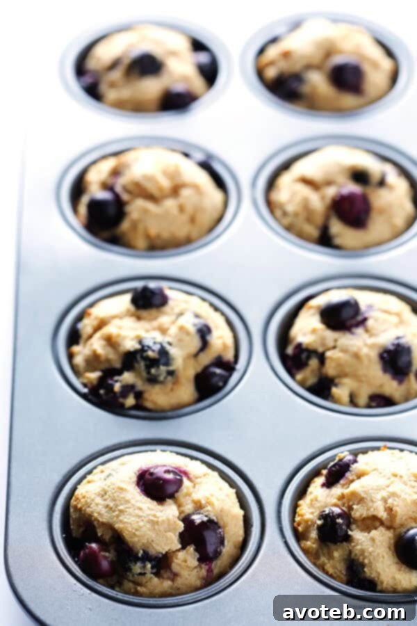 Overhead shot of Healthier Blueberry Muffins cooling, showing off their perfectly rounded tops and uniform baking. | gimmesomeoven.com