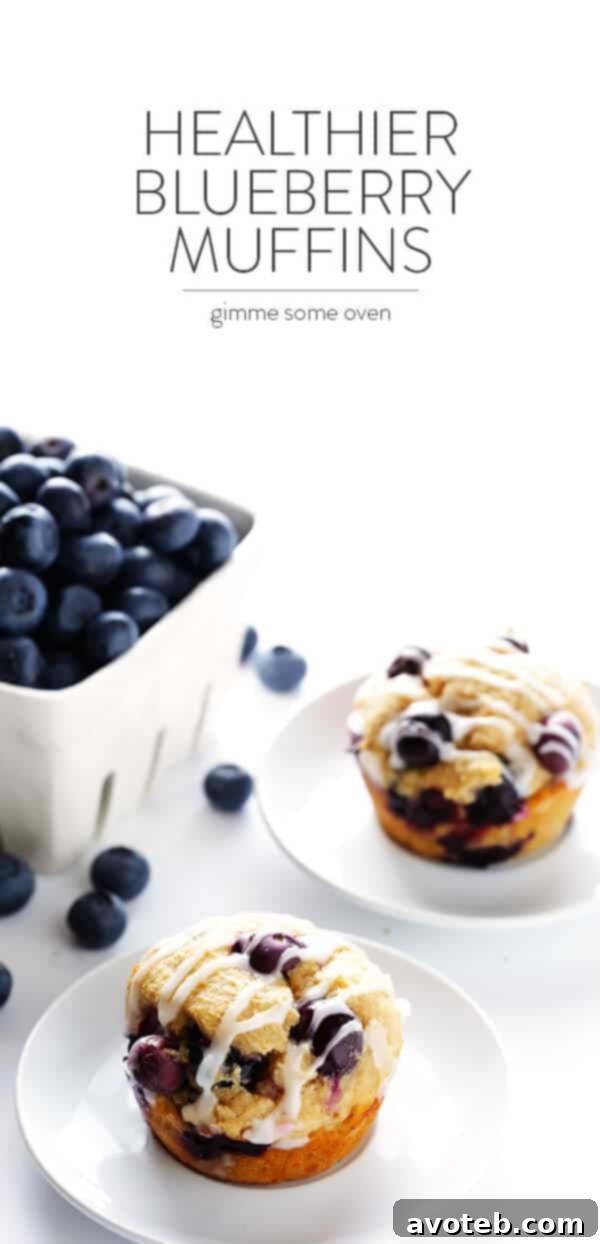 A beautifully composed shot of Healthier Blueberry Muffins on a wooden board with fresh blueberries and a pitcher of almondmilk, highlighting their natural goodness. | gimmesomeoven.com