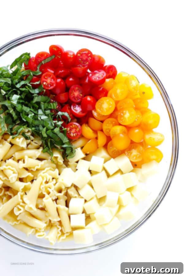 This Caprese Pasta Salad Recipe is quick and easy to make, tossed with a delicious balsamic vinaigrette, and perfect for picnics, potlucks, or just a regular weeknight meal! | gimmesomeoven.com