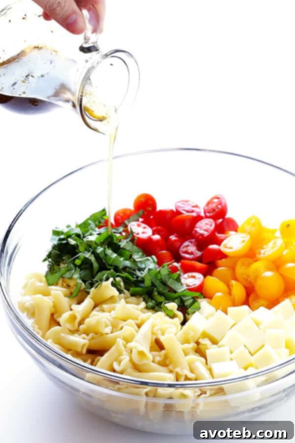 This Caprese Pasta Salad Recipe is quick and easy to make, tossed with a delicious balsamic vinaigrette, and perfect for picnics, potlucks, or just a regular weeknight meal! | gimmesomeoven.com