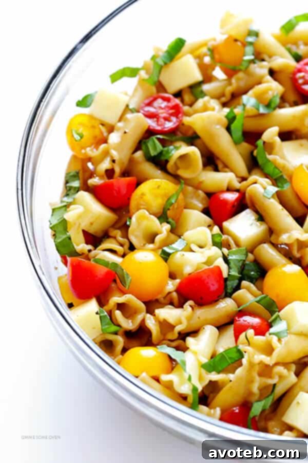 This Caprese Pasta Salad Recipe is quick and easy to make, tossed with a delicious balsamic vinaigrette, and perfect for picnics, potlucks, or just a regular weeknight meal! | gimmesomeoven.com