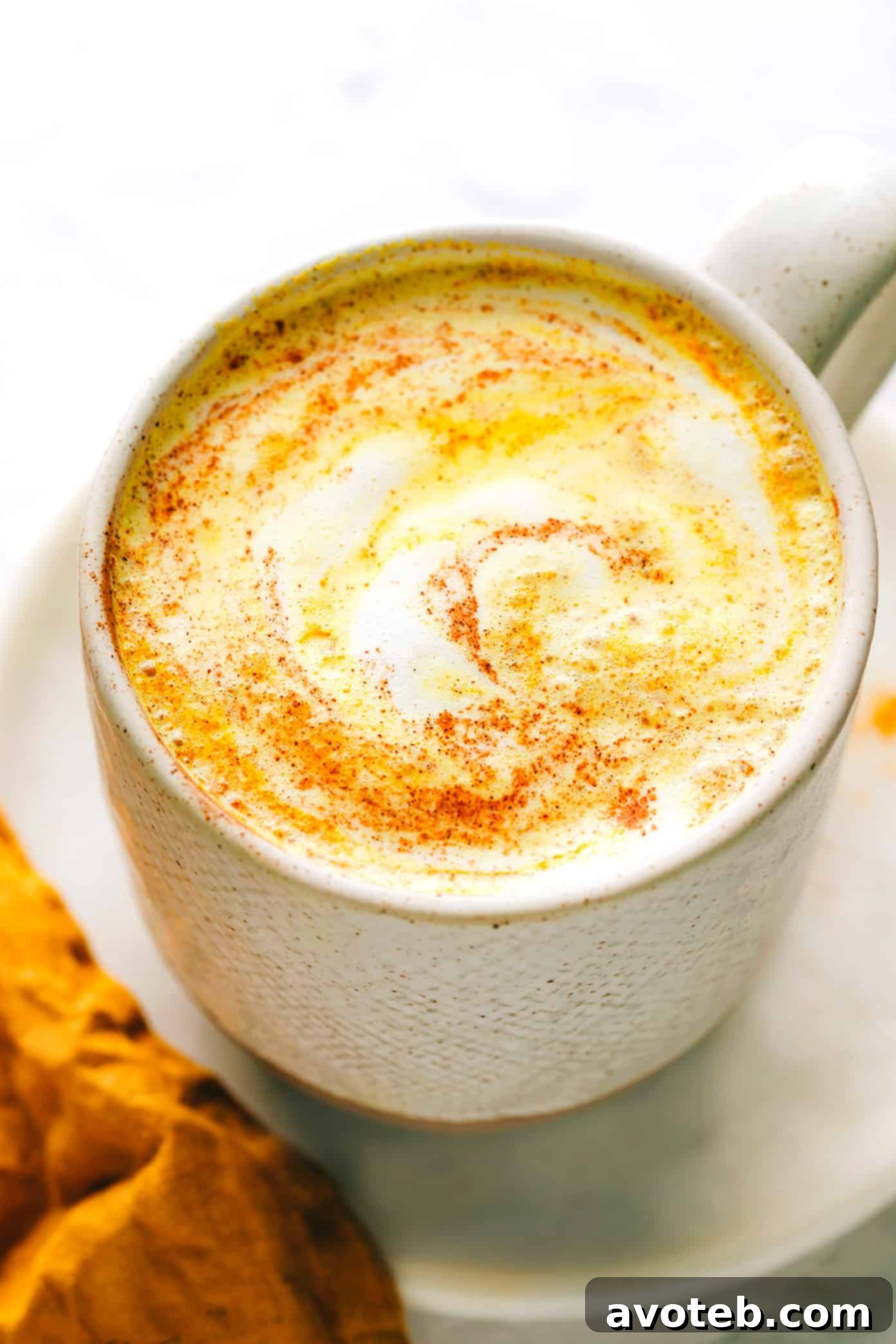 A beautifully styled mug of golden milk, rich in turmeric, promising warmth and comfort.