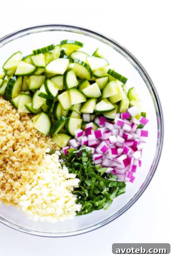 Vibrant Quinoa Cucumber Medley 3 Close-up of the fresh ingredients for Cucumber Quinoa Salad: crisp cucumber, vibrant basil, crumbled feta, and diced red onion.