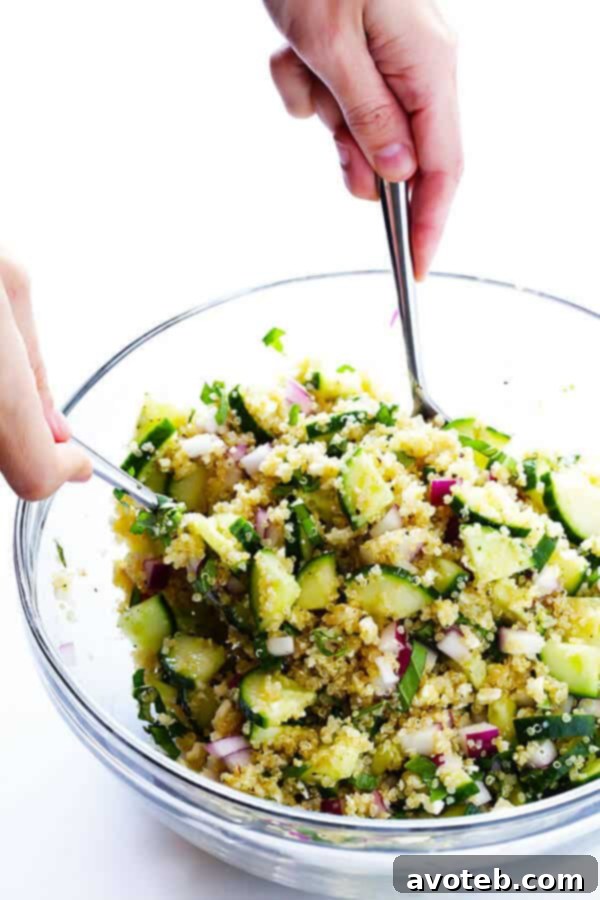 Vibrant Quinoa Cucumber Medley 5 Preparation step: Drizzling the homemade lemony vinaigrette over the cucumber, quinoa, feta, basil, and red onion mixture.
