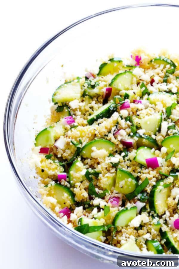 Vibrant Quinoa Cucumber Medley 6 Preparation step: Tossing the Cucumber Quinoa Salad to evenly distribute the vinaigrette and combine all ingredients.
