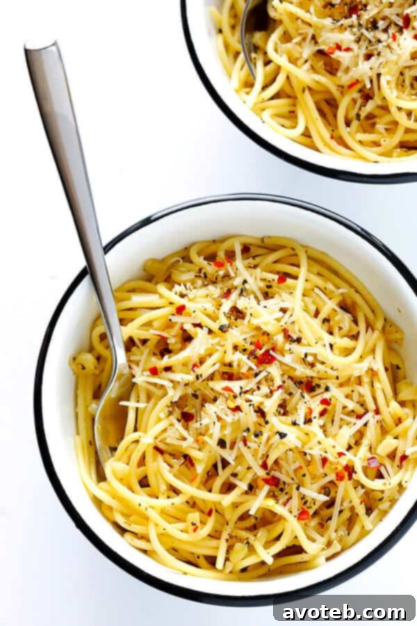 Bold Garlic Spaghetti 5 Finished plate of Garlic Lovers' Spaghetti garnished with Parmesan and red pepper flakes.
