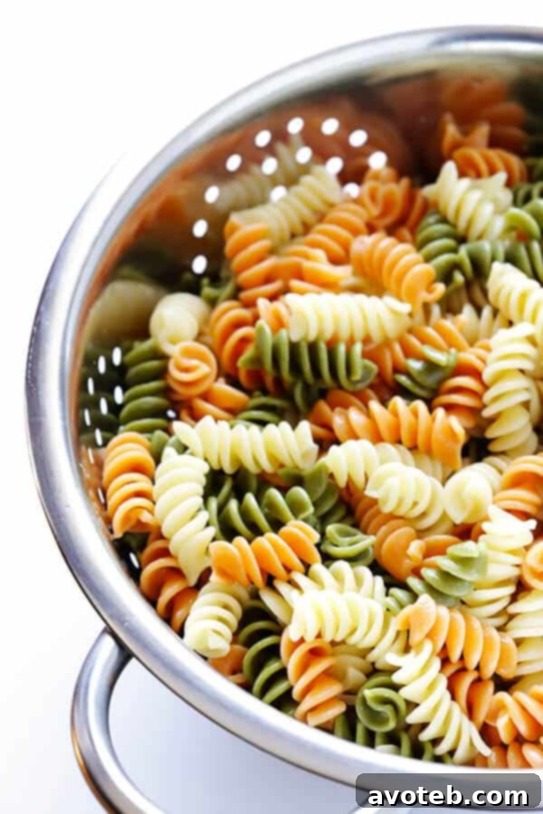 This Rainbow Antipasto Pasta Salad is the perfect way to use up leftover antipasto ingredients! Plus, it's easy to make, tossed with a zesty Italian herb vinaigrette, and absolutely delicious! | gimmesomeoven.com