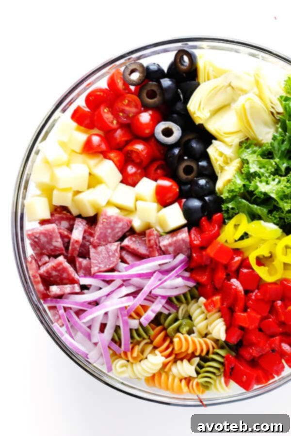 This Rainbow Antipasto Pasta Salad is the perfect way to use up leftover antipasto ingredients! Plus, it's easy to make, tossed with a zesty Italian herb vinaigrette, and absolutely delicious! | gimmesomeoven.com