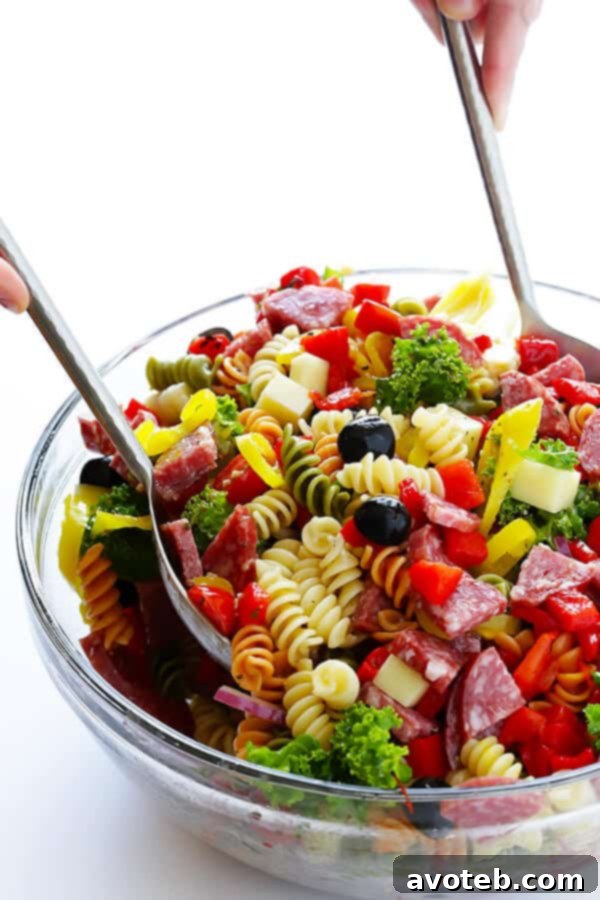 This Rainbow Antipasto Pasta Salad is the perfect way to use up leftover antipasto ingredients! Plus, it's easy to make, tossed with a zesty Italian herb vinaigrette, and absolutely delicious! | gimmesomeoven.com