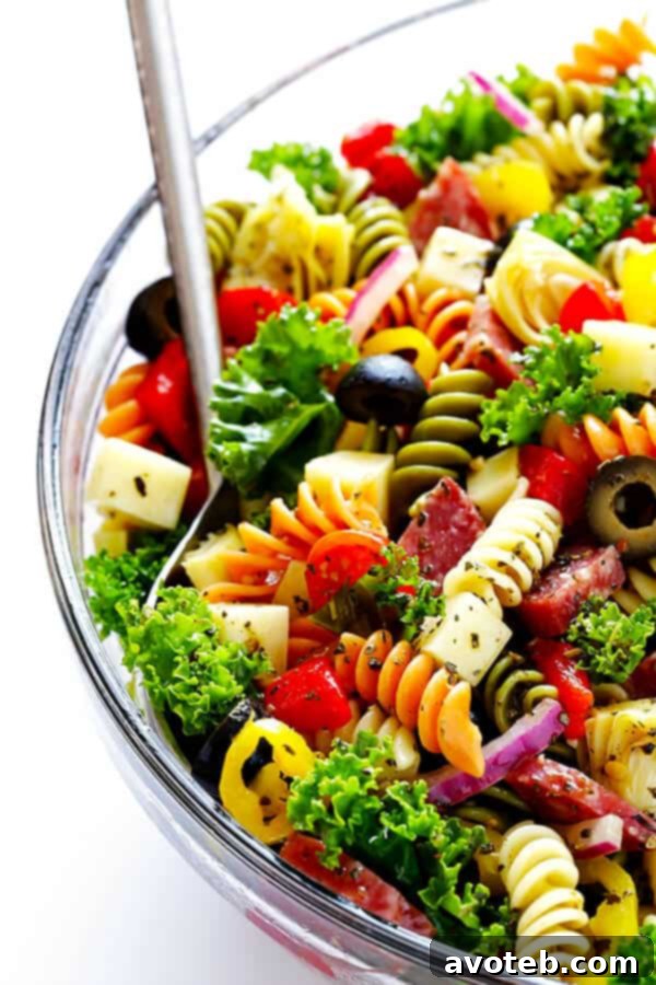 This Rainbow Antipasto Pasta Salad is the perfect way to use up leftover antipasto ingredients! Plus, it's easy to make, tossed with a zesty Italian herb vinaigrette, and absolutely delicious! | gimmesomeoven.com