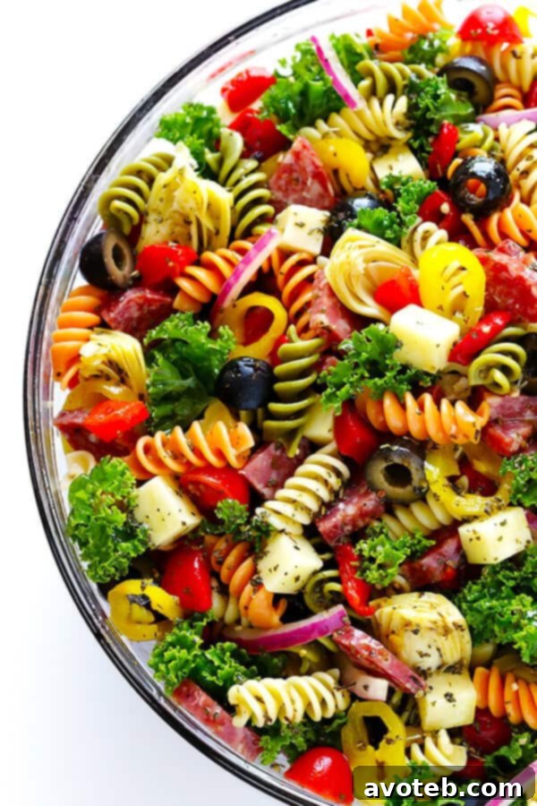 This Rainbow Antipasto Pasta Salad is the perfect way to use up leftover antipasto ingredients! Plus, it's easy to make, tossed with a zesty Italian herb vinaigrette, and absolutely delicious! | gimmesomeoven.com