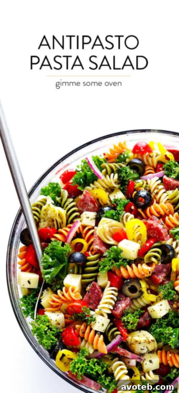 A large serving of Rainbow Antipasto Pasta Salad with a variety of colorful ingredients and zesty Italian herb vinaigrette.