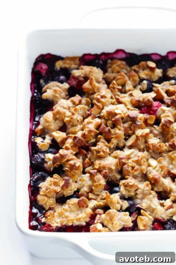 Berry Almond Crisp layered in a baking dish, before baking.