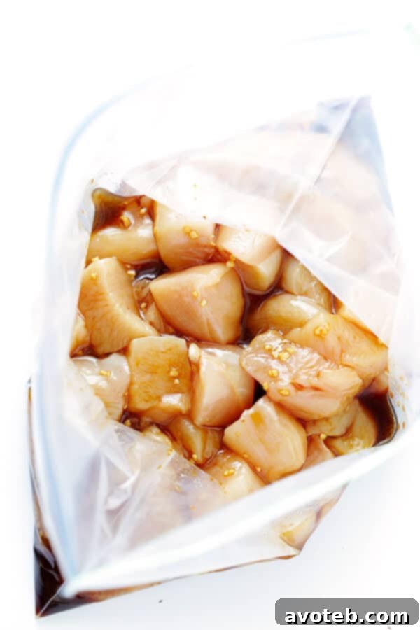 Juicy chicken pieces marinating in a flavorful citrus teriyaki sauce, ready to absorb delicious flavors.