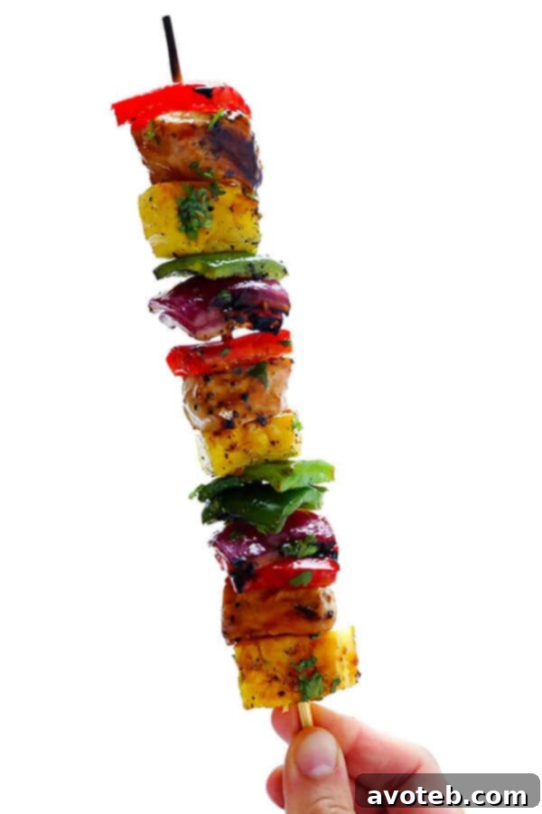 A vibrant platter of Rainbow Hawaiian Chicken Kabobs garnished with fresh cilantro, ready to be enjoyed.