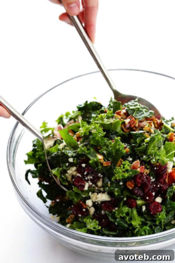 Smoky Bacon & Bold Blue Cheese Kale Salad 6 A large bowl of Kale Salad with Bacon and Blue Cheese being tossed with the homemade Red Wine Shallot Vinaigrette.