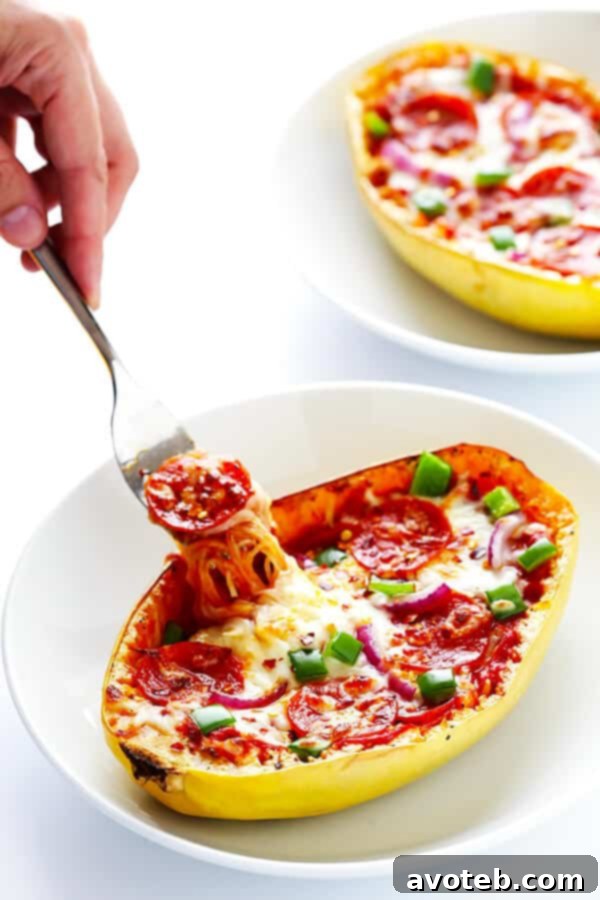 Close-up of a Pizza Spaghetti Squash Boat, showcasing the roasted squash filled with cheesy pizza goodness and fresh basil.