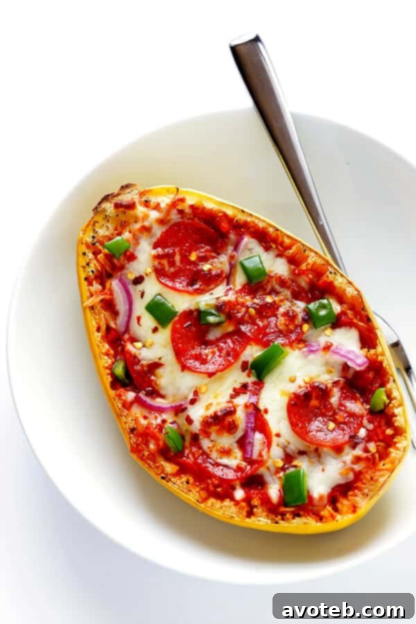 A top-down view of a single Pizza Spaghetti Squash Boat, highlighting the vibrant toppings and perfectly melted cheese.