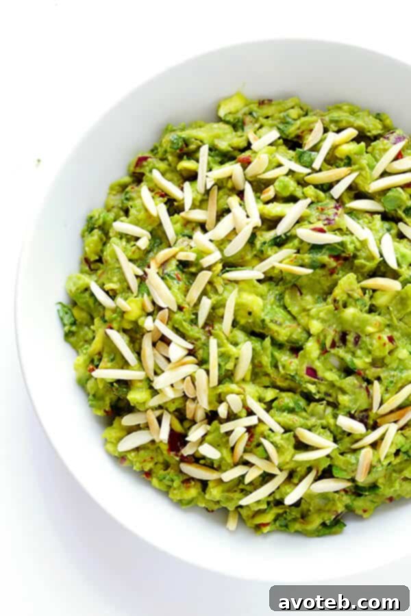 This Toasted Almond and Chipotle Guacamole recipe is easy to make in about 10 minutes, and it's absolutely IRRESISTIBLE. Trust me. | gimmesomeoven.com (Vegan + Gluten Free)