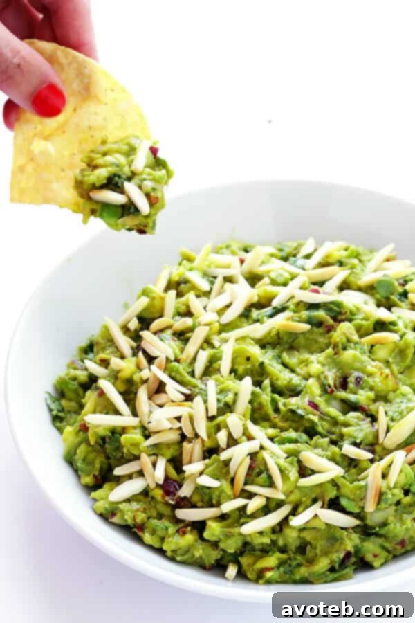 This Toasted Almond and Chipotle Guacamole recipe is easy to make in about 10 minutes, and it's absolutely IRRESISTIBLE. Trust me. | gimmesomeoven.com (Vegan + Gluten Free)