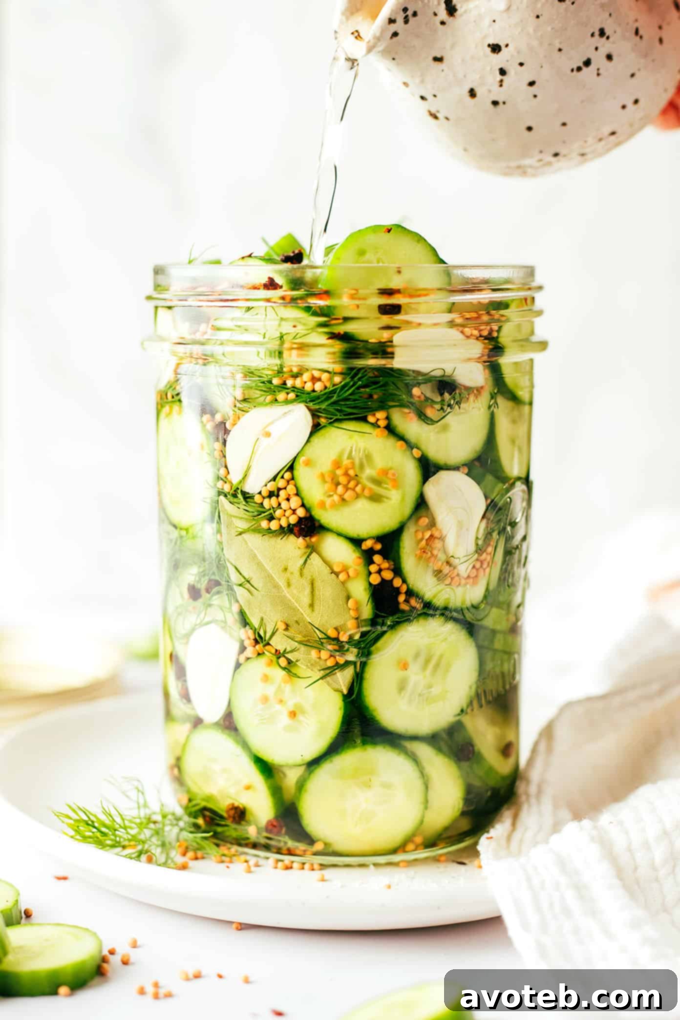 Variety of homemade pickle jars with different seasonings and styles.