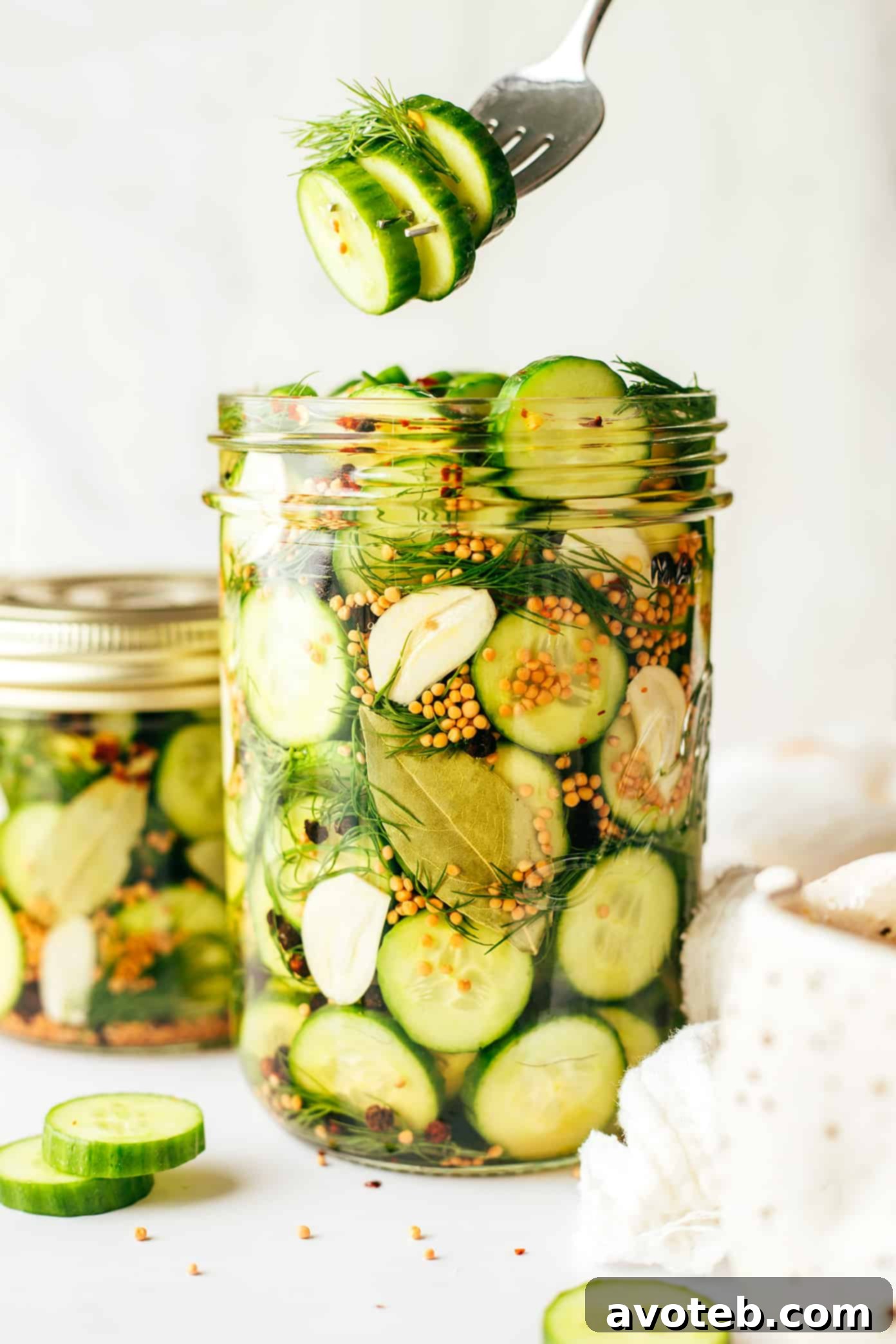A stack of pickle jars on a kitchen counter, showcasing different sizes.