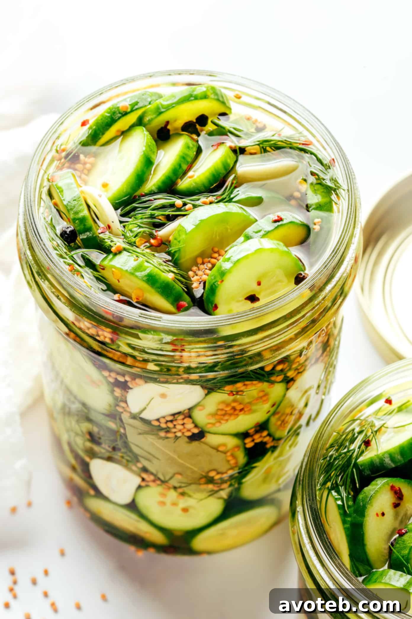 Various sizes of pickling jars with different lids.
