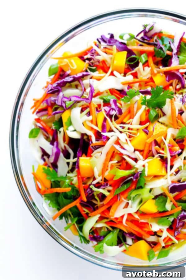 This Mango Chipotle Fish Tacos recipe is made with flaky mild fish, filled with a zesty mango slaw, and drizzled with a creamy chipotle lime sauce. So easy to make, and ready to go in less than 30 minutes! | gimmesomeoven.com