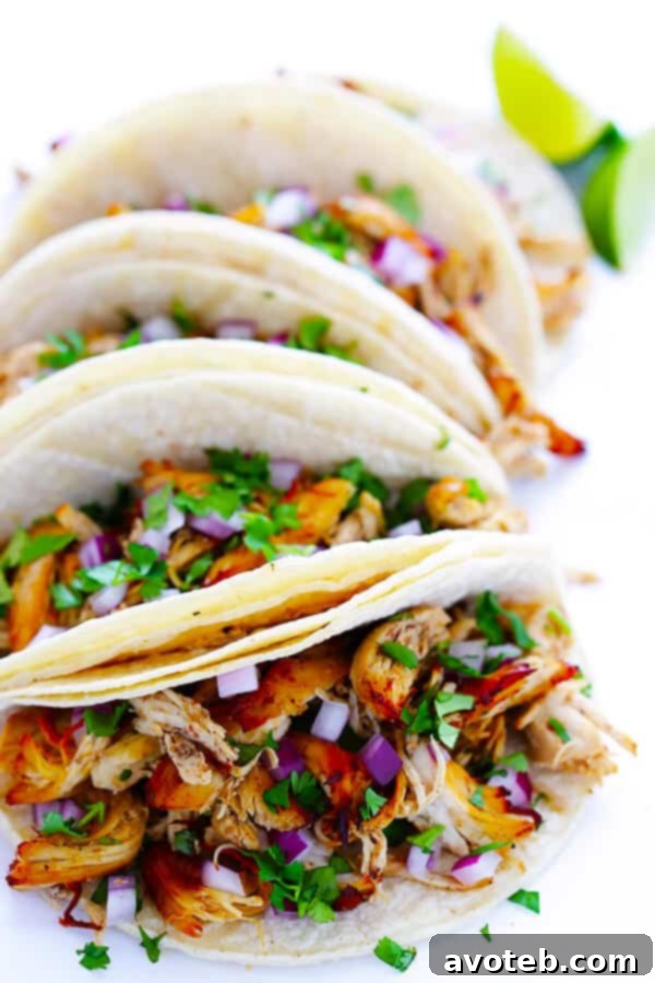 Serving crispy chicken carnitas in tacos with fresh toppings