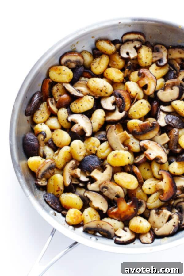 Assortment of fresh mushrooms, including shiitake and baby bella, ready to be sliced for the gnocchi recipe.