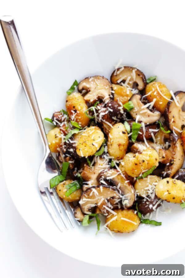 Toasted Gnocchi with Mushrooms, Basil and Parmesan in a pan, ready to be served as a delightful vegetarian meal.
