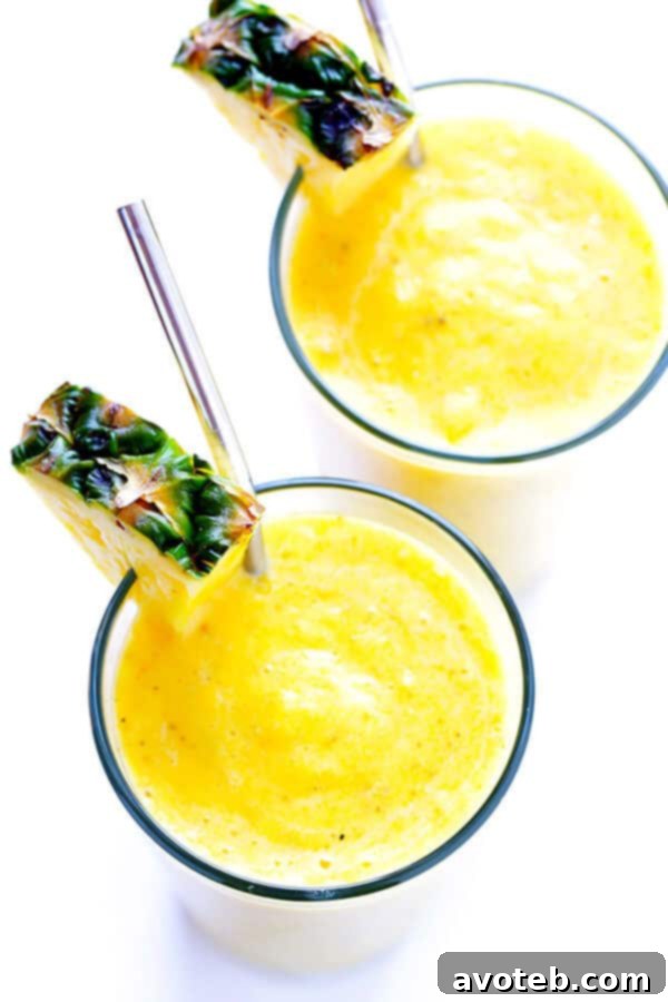 Freshly blended Feel-Good Pineapple Smoothie poured into a glass.