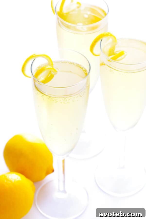 Elegant French 75 Cocktail garnished with a perfectly coiled Lemon Twist