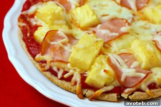 Quick & Easy Hawaiian Pita Pizzas Recipe Delicious and healthy Hawaiian Pita Pizza with pineapple and Canadian bacon, served on a wooden board
