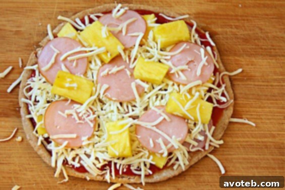 Easy Homemade Hawaiian Pita Pizza Freshly baked Hawaiian Pita Pizza ready to be served, cut into wedges