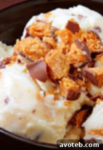 Scoops of homemade Butterfinger ice cream in a cone and bowl