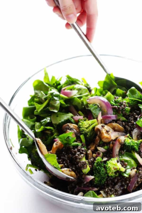 Invigorating Lentil & Spinach Medley 7 Cooked lentils, sautéed vegetables, and fresh spinach tossed together in a large bowl, ready for the lemon dressing in the Zesty Lentil Spinach Salad.